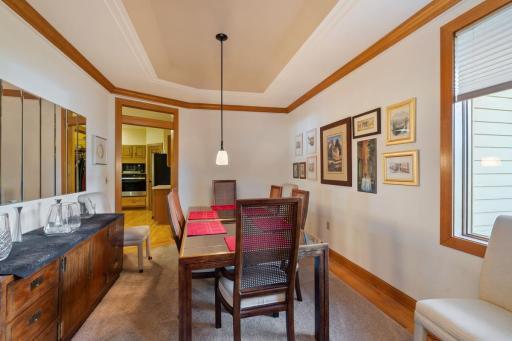 Formal dining room with race track ceiling and transom window