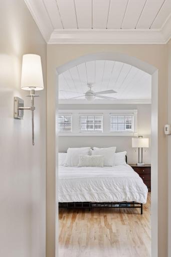 Upstairs, the primary bedroom suite is a serene escape, with French doors opening to a private balcony.