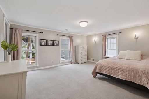 Four additional bedrooms, a full bathroom, and laundry complete the upper level.