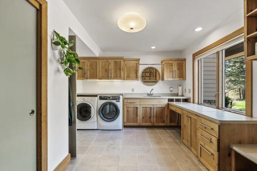 Function meets style in this spacious mudroom, with built-in storage, laundry, and organization for every season.