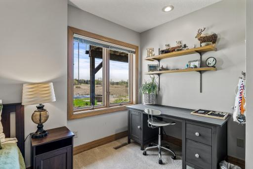 Spacious bedroom enjoys views of the pond.