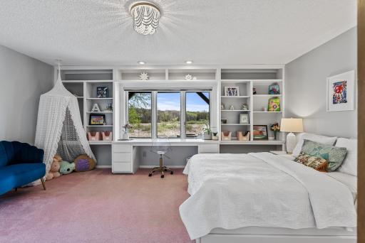 With generous proportions and sun-drenched windows, this lower-level bedroom offers comfort, light, and flexibility.