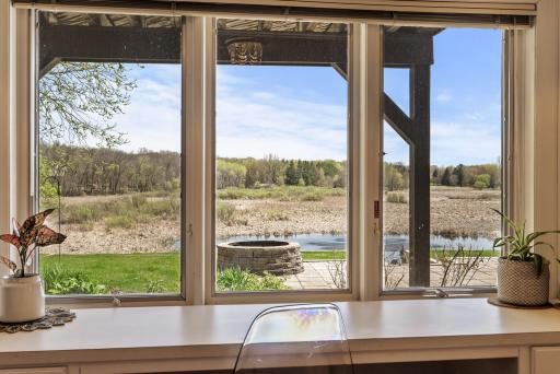 Wake up to beautiful backyard views in this bright walkout-level bedroom, where large windows bring the outdoors in.