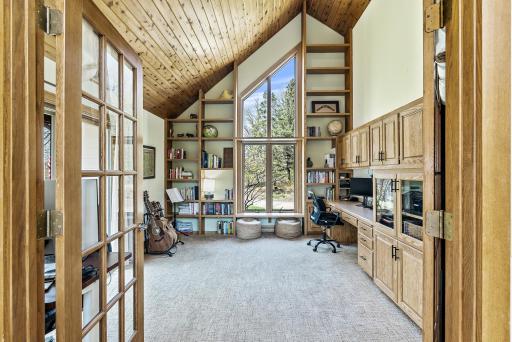 Work feels anything but ordinary in this stunning office, featuring vaulted ceilings and expansive windows that flood the space with natural light and inspiring views. A perfect blend of productivity and peace.