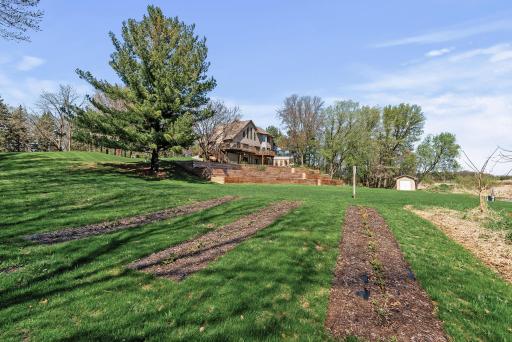 Versatility meets charm: three outdoor sheds offer storage and recreationâincluding a cozy warming house for winter pond skating.