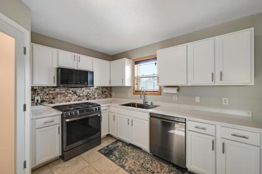 Kitchen features motion detected under cabinet lighting, fresh paint and new hardware