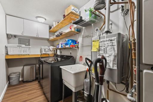 Main Floor Laundry & Mechanics Room with New Washer/Dryer and On Demand Water heater