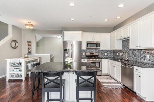 Granitite counters, tile backsplash, white cabinets,