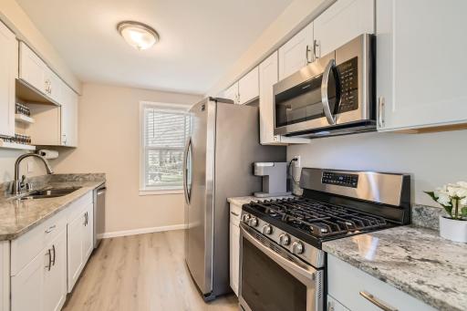 Beautiful kitchen with granite counters and SS appliances.