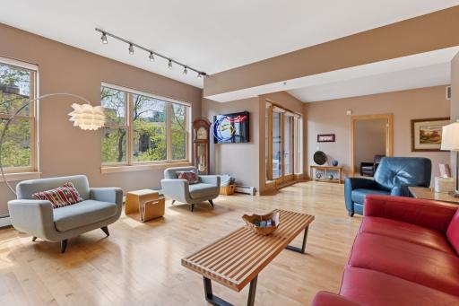 Defined living room with high ceilings, large windows