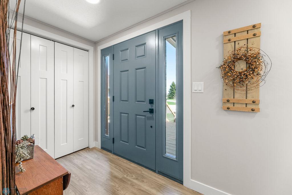 Front door flanked with sidelights and coat closet at your entry