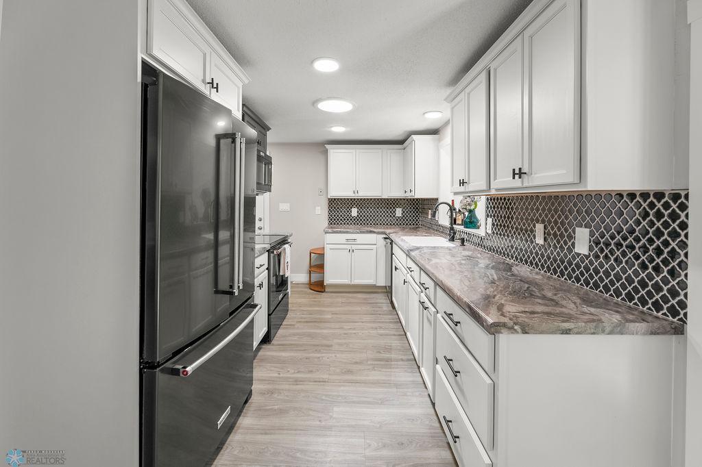 Gorgeous galley kitchen overlooks your unique family room space down below