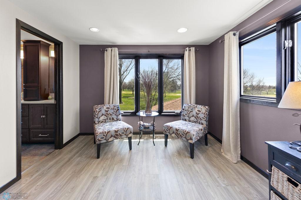 Your spacious master offers a seating space and big windows with a golf course view