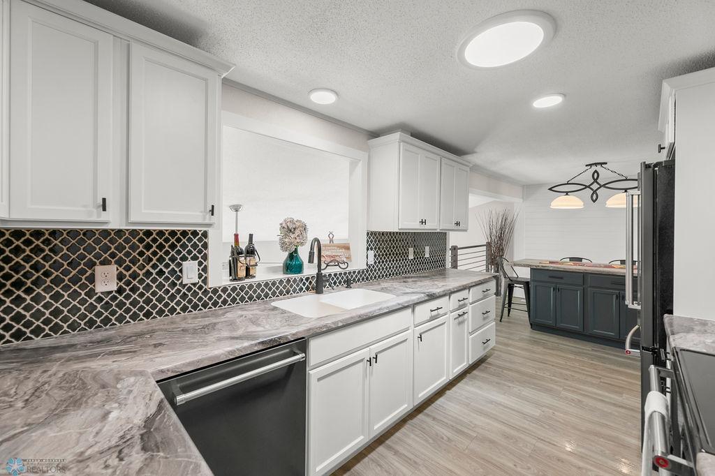 White kitchen w/ stainless appliances