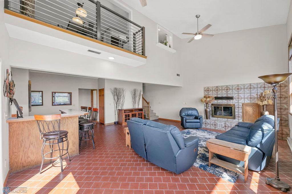 Tile floors, vaulted ceilings, ceiling fan, modern cable railing.