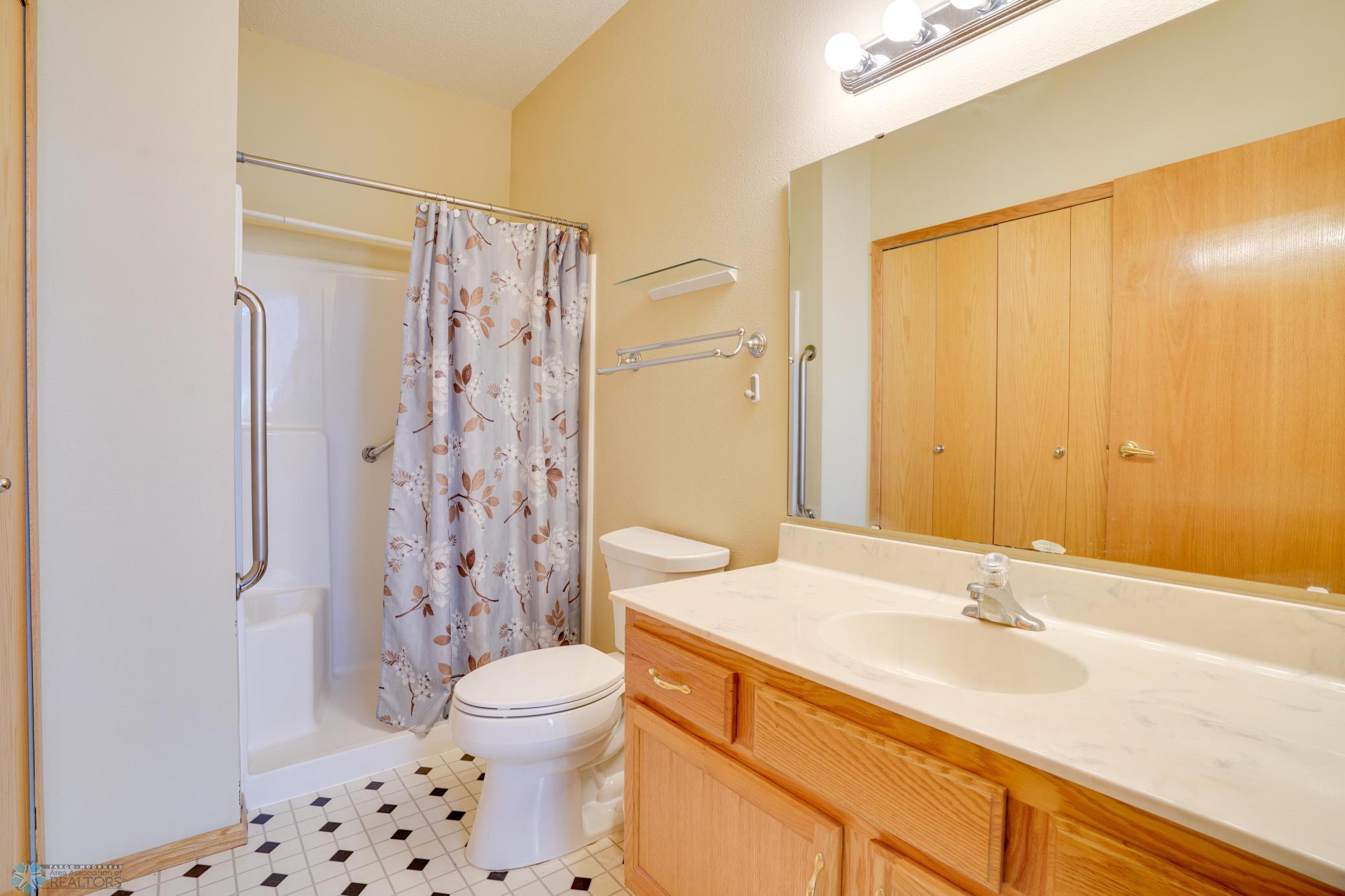 3/4 bathroom with walk-in shower & seat in shower