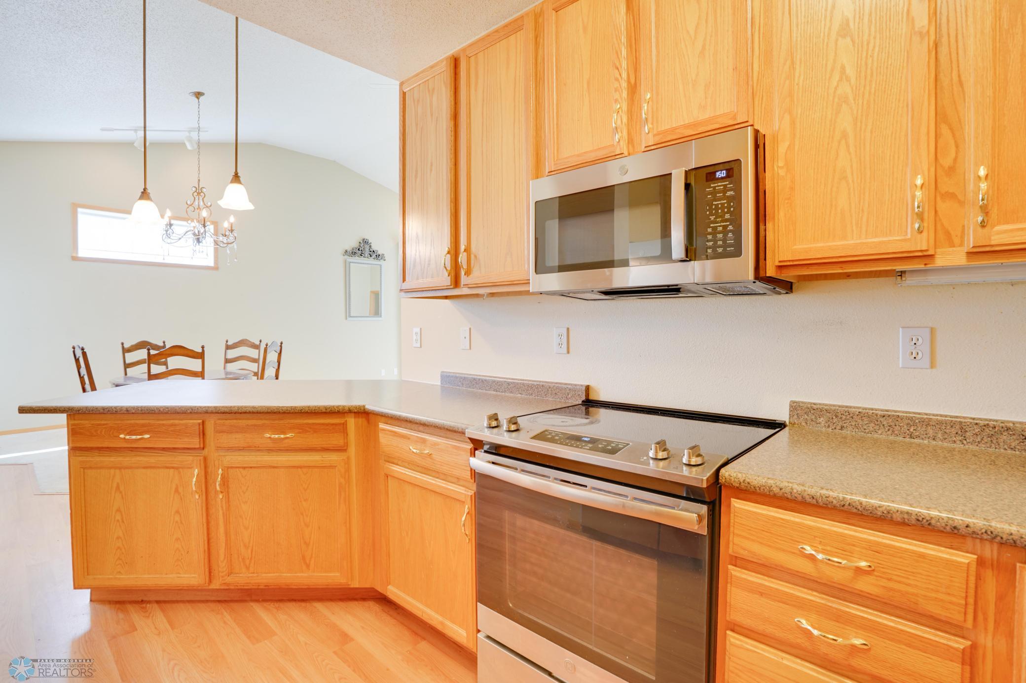 Kitchen looks out to Dining & Living