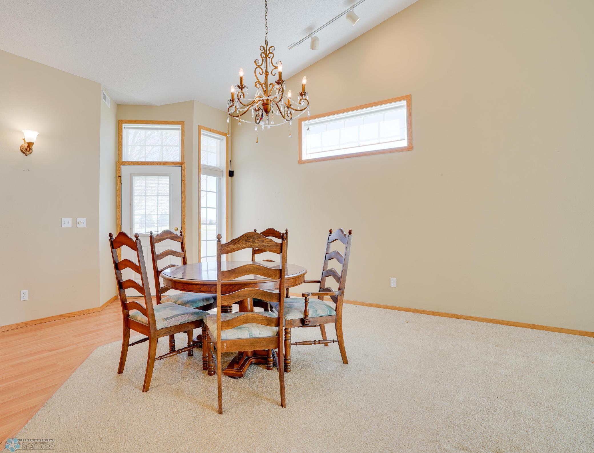 Entry to dining area w/ transom window, vaulted ceilings, open-concept floorplan