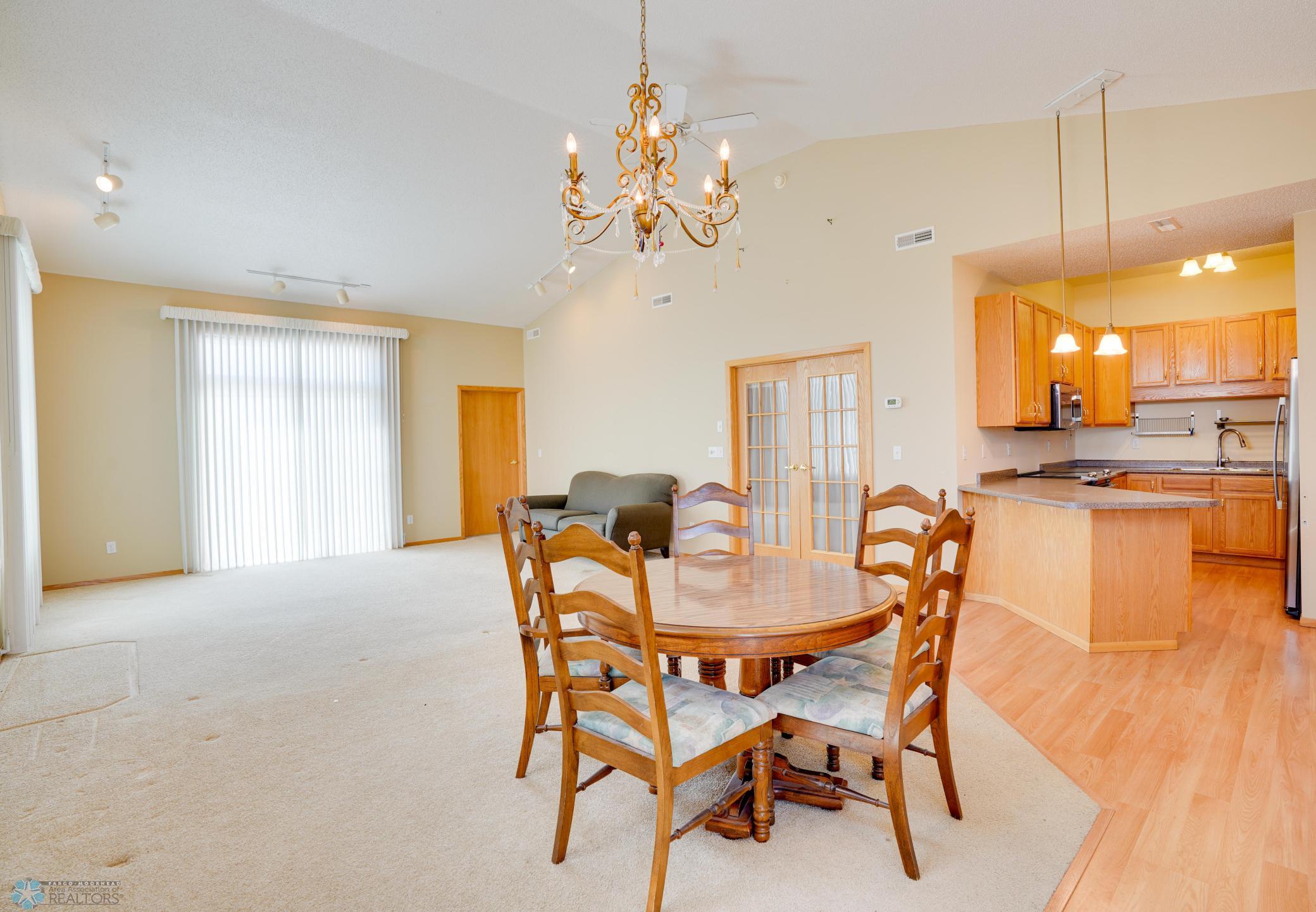 Dining area & living room open to kitchen with breakfast bar seating