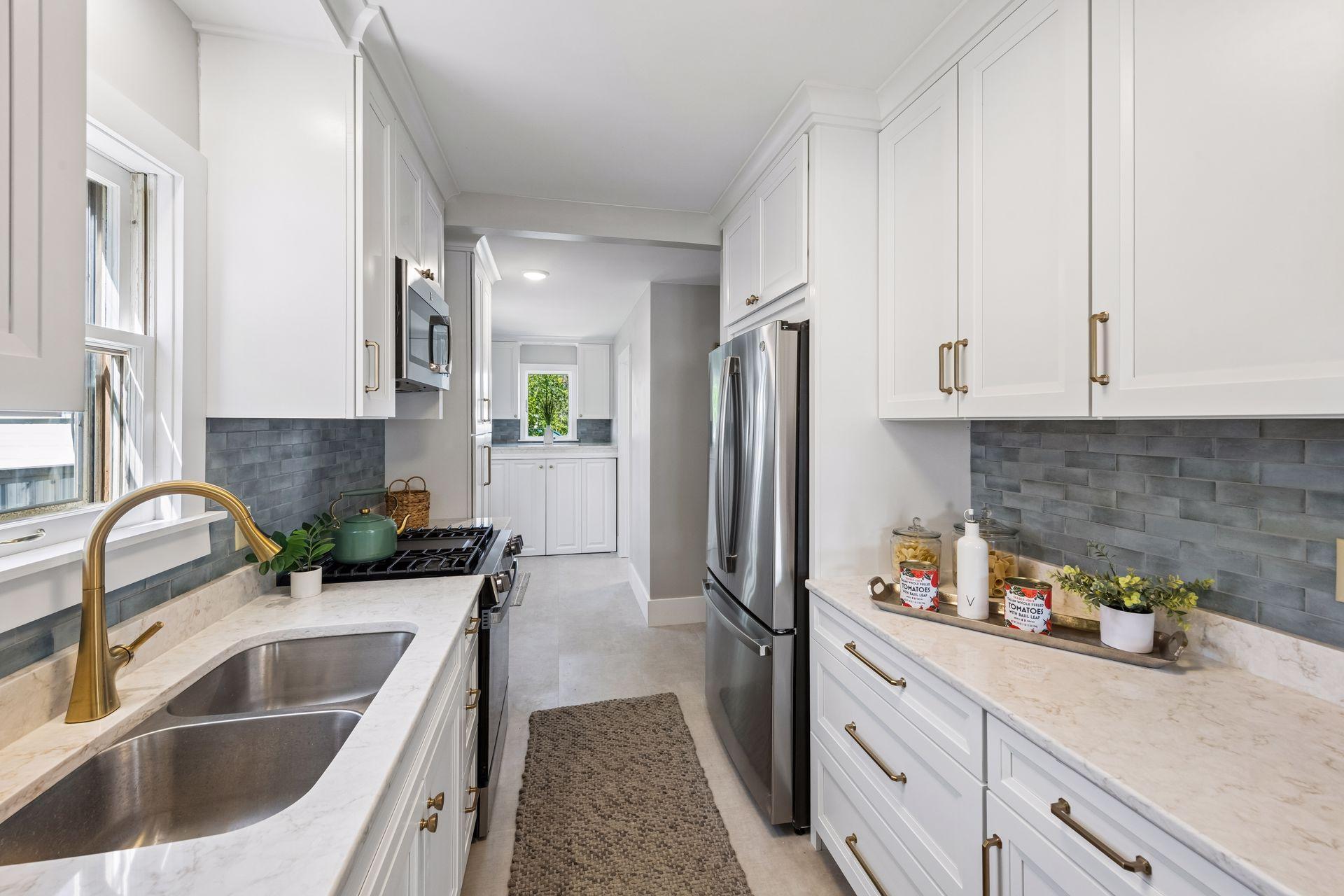 Everthing in this kitchen is new - cabinetry, quartz countertops, handles, sink, appliances, faucet, flooring, lighting. Every inch was touch with elegance.
