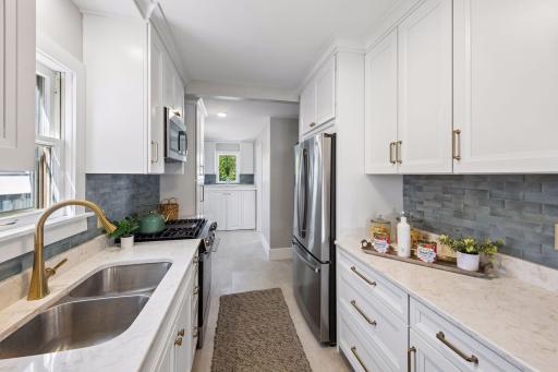 Everthing in this kitchen is new - cabinetry, quartz countertops, handles, sink, appliances, faucet, flooring, lighting. Every inch was touch with elegance.