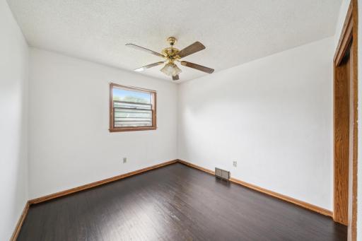 Upper level bedroom with refinished hardwood floor.