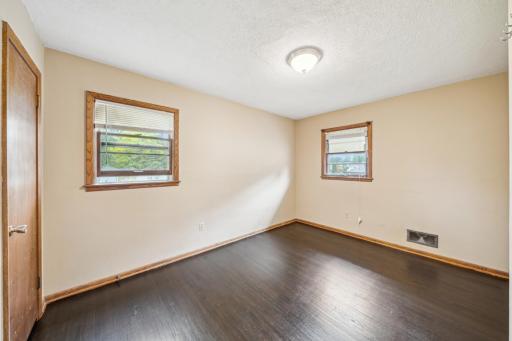 Upper level bedroom with refinished hardwood floor.