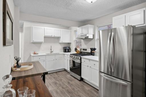 The kitchen has abundant storage, a pantry, and LVP flooring.