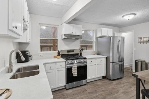 The spacious 16x9 updated kitchen has newer stainless steel appliances and quartz countertops.