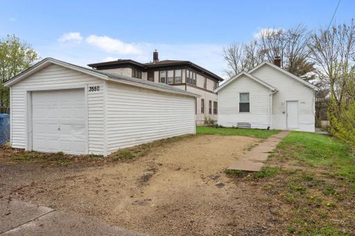 An oversized 23x14 one-car garage. A gravel parking pad alongside the garage.