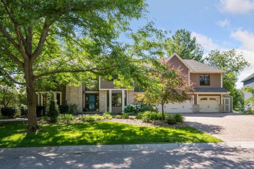 Timeless two story home on Lake Edward with great curb appeal, paver driveway, lush landscaping and additional storage shed, directly across from park trails and located in the Wayzata School district!