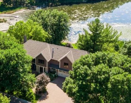 Welcome home to 6465 Glacier Lane! Timeless two-story nestled on an incredible west facing lakefront lot in sought after Wayzata school district.