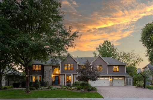 Timeless two story home on Lake Edward with great curb appeal, paver driveway, lush landscaping and additional storage shed, directly across from park trails and located in the Wayzata School district!