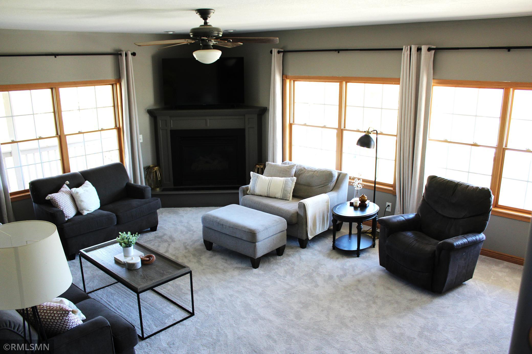 The 19'x16' living room offers plenty of seating around the cozy gas-burning fireplace
