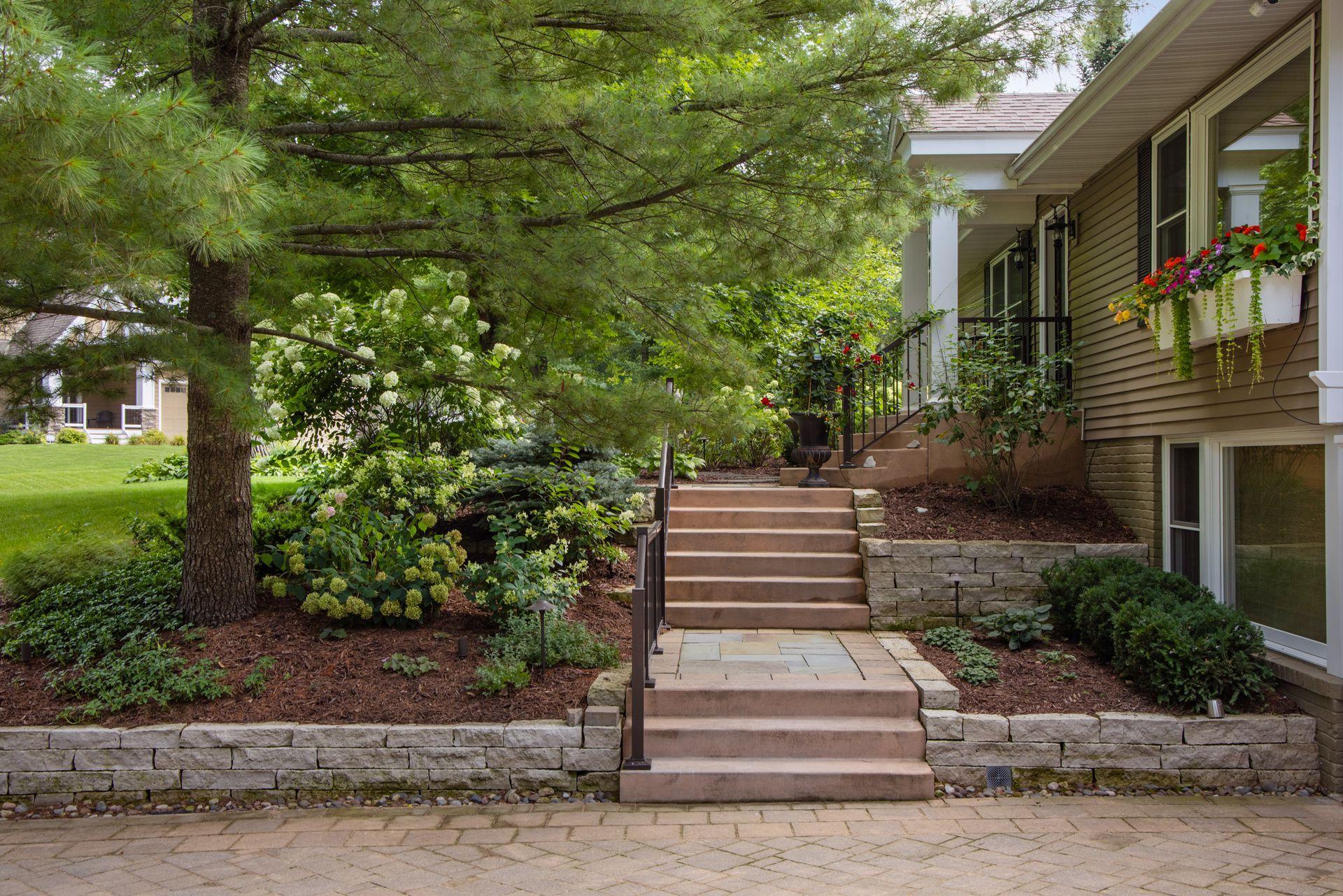 The grand custom steps up to the front entry highlight the pretty landscape