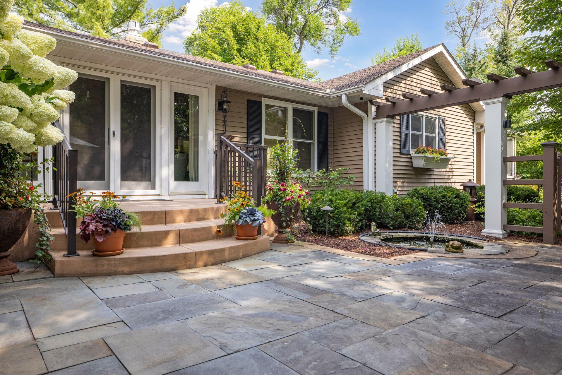 The exterior of this home was so thoughtfully designed with water and fire features and flower boxes for the perfect pop of color