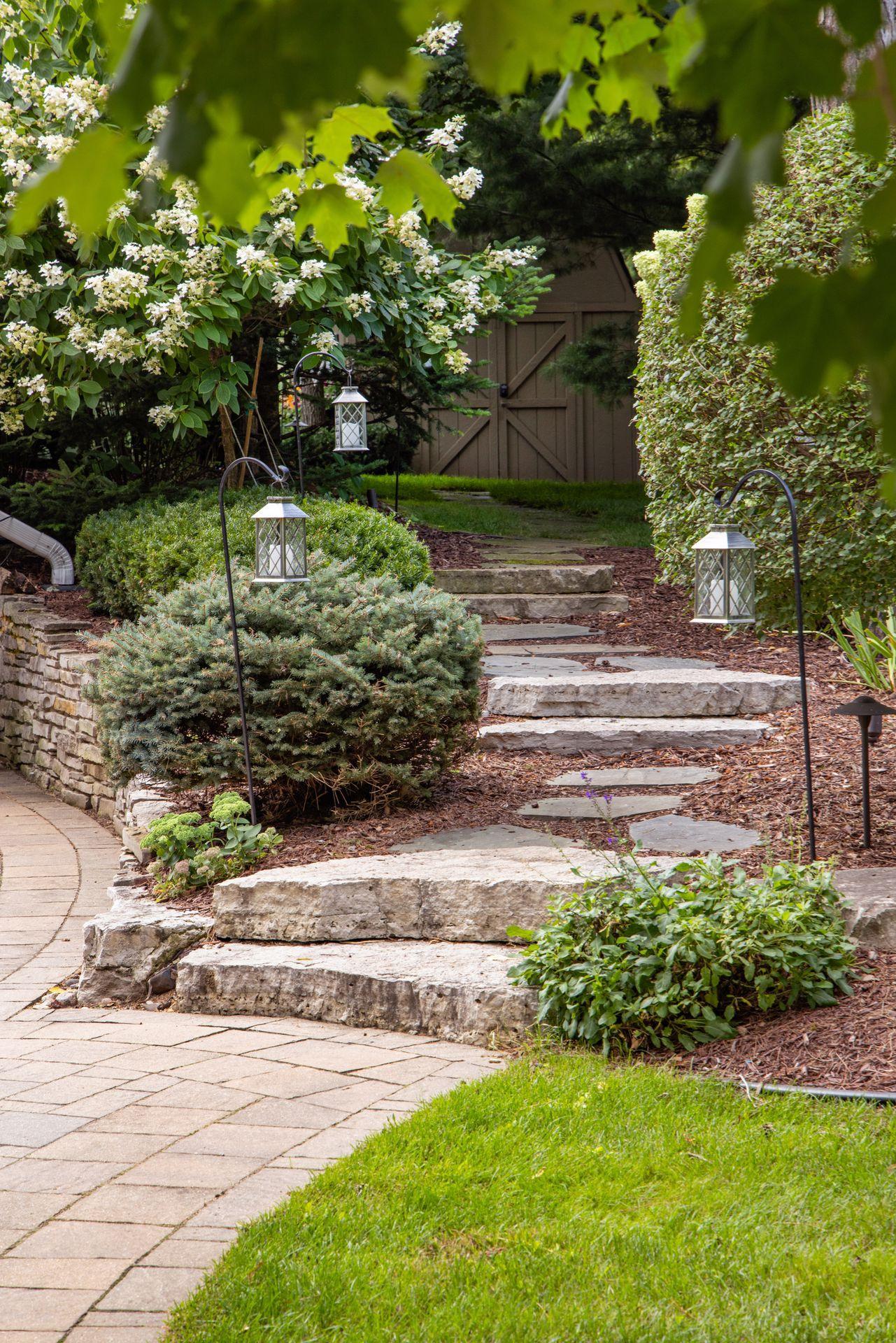Custom stone stairway leads to the backyard from the driveway