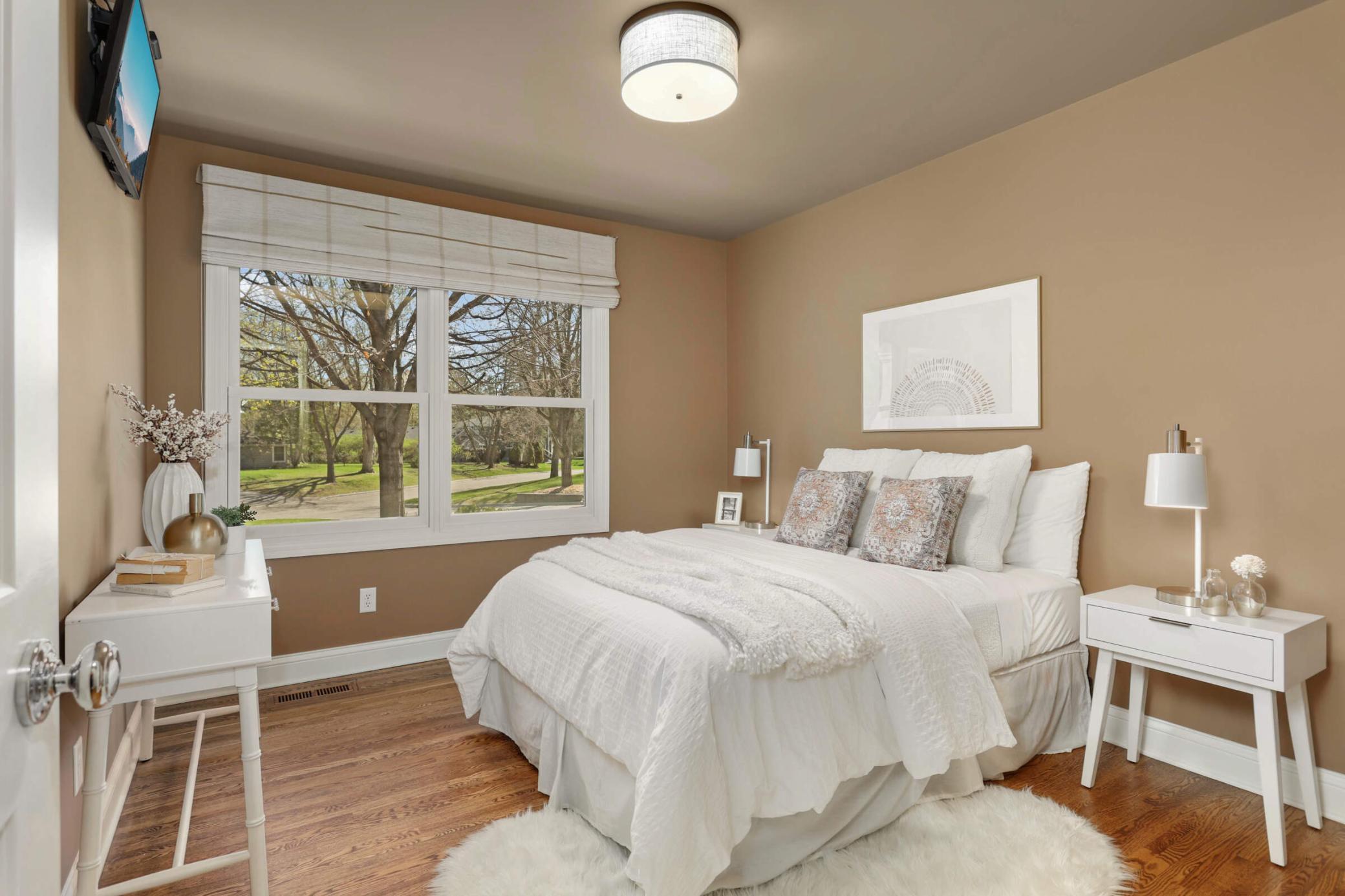 The 2nd bedroom on the main floor overlooks the lush front yard.
