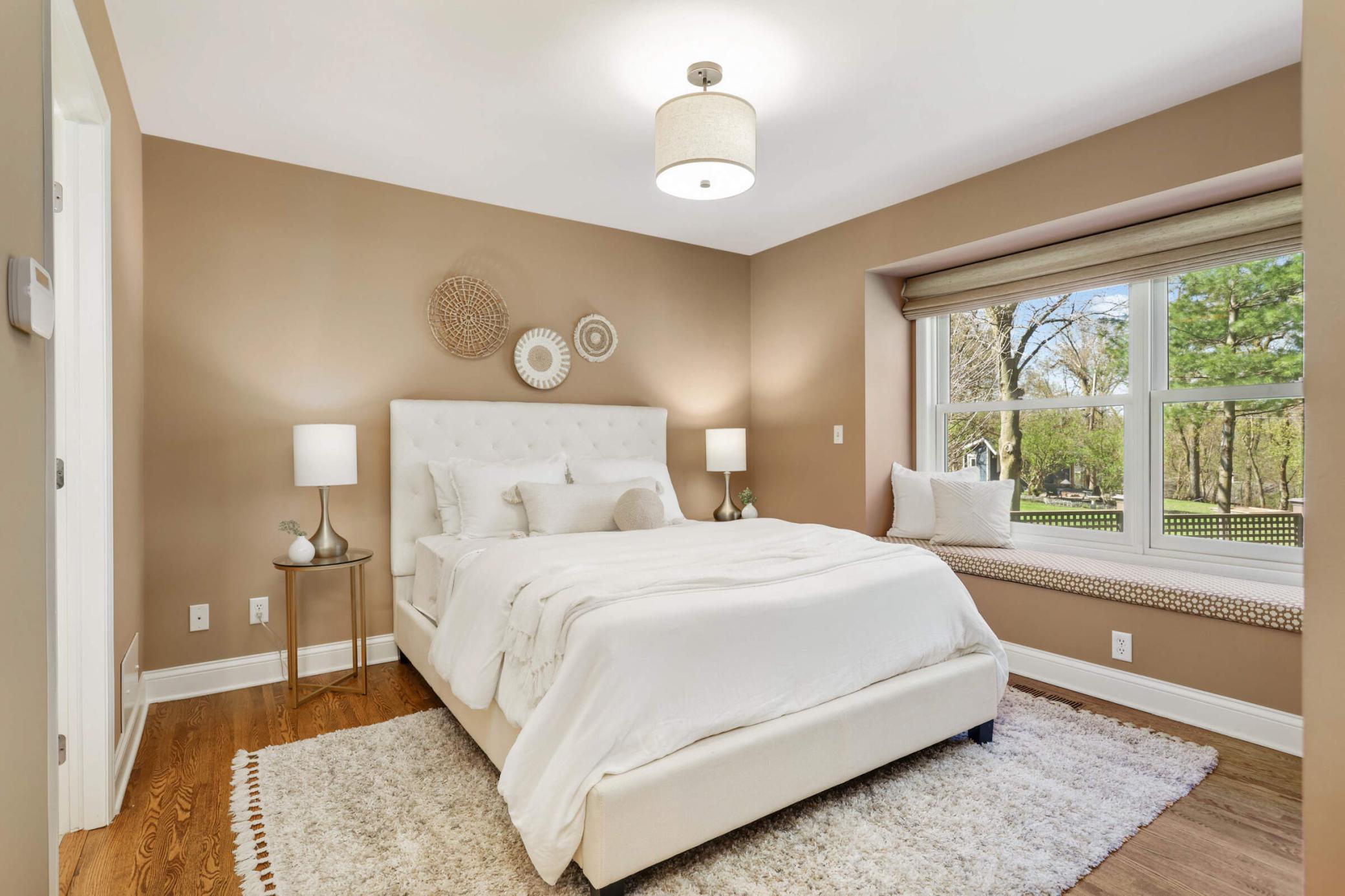 Main floor primary suite overlooks the backyard