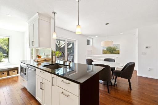 Open kitchen with granite counter tops and custom cabinetry.