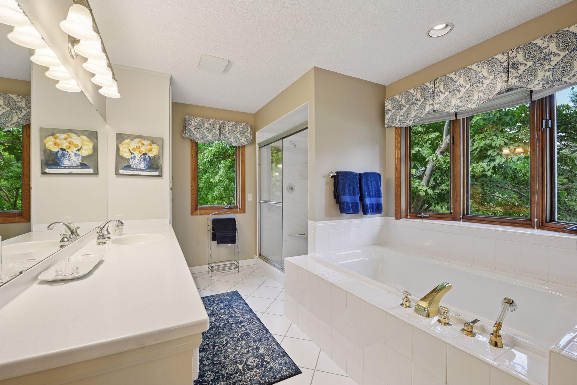 Spacious primary bath with separate walk-in shower and large whirlpool tub