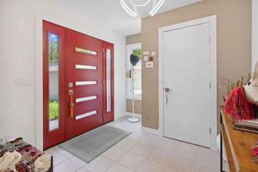 Ample front entryway with fresh paint and updated lighting.