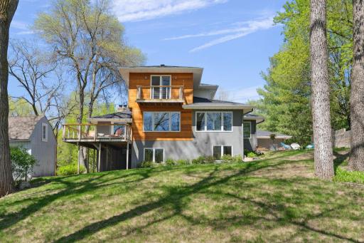 A wonderful deck with new railing off the formal dining room, offering stunning lake views and a serene natural backdrop