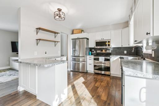 Updated kitchen with stainless steel appliances and lovely backsplash~