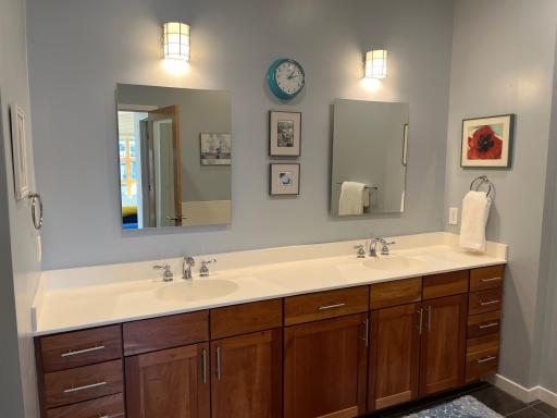 Primary bath with dual sinks, cherry cabinetry and tile floors!