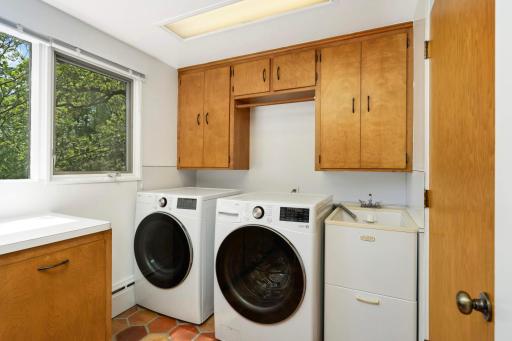 Spacious laundry with newer side by side front load washer and dryer.