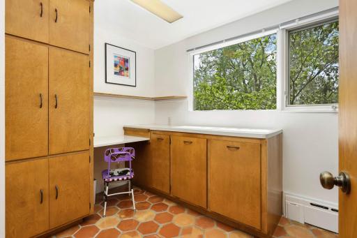 Lots of storage in the laundry room with built in laundry bins as well!