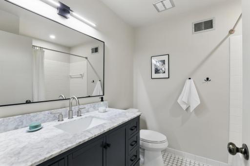 Main full bath with a new vanity and updated fixturesâclean and refreshed.
