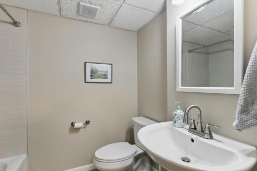 Full bath in the lower level features a brand-new tub with a sleek tile surround. Updated and spaciousâperfect for guests or added convenience.