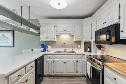 Freshly painted cabinets and a new sink give the kitchen a clean, refreshed look.
